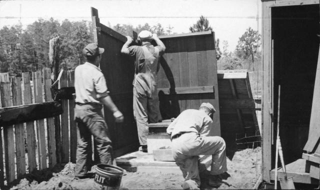 CPS workers assembling a privy at Camp 27